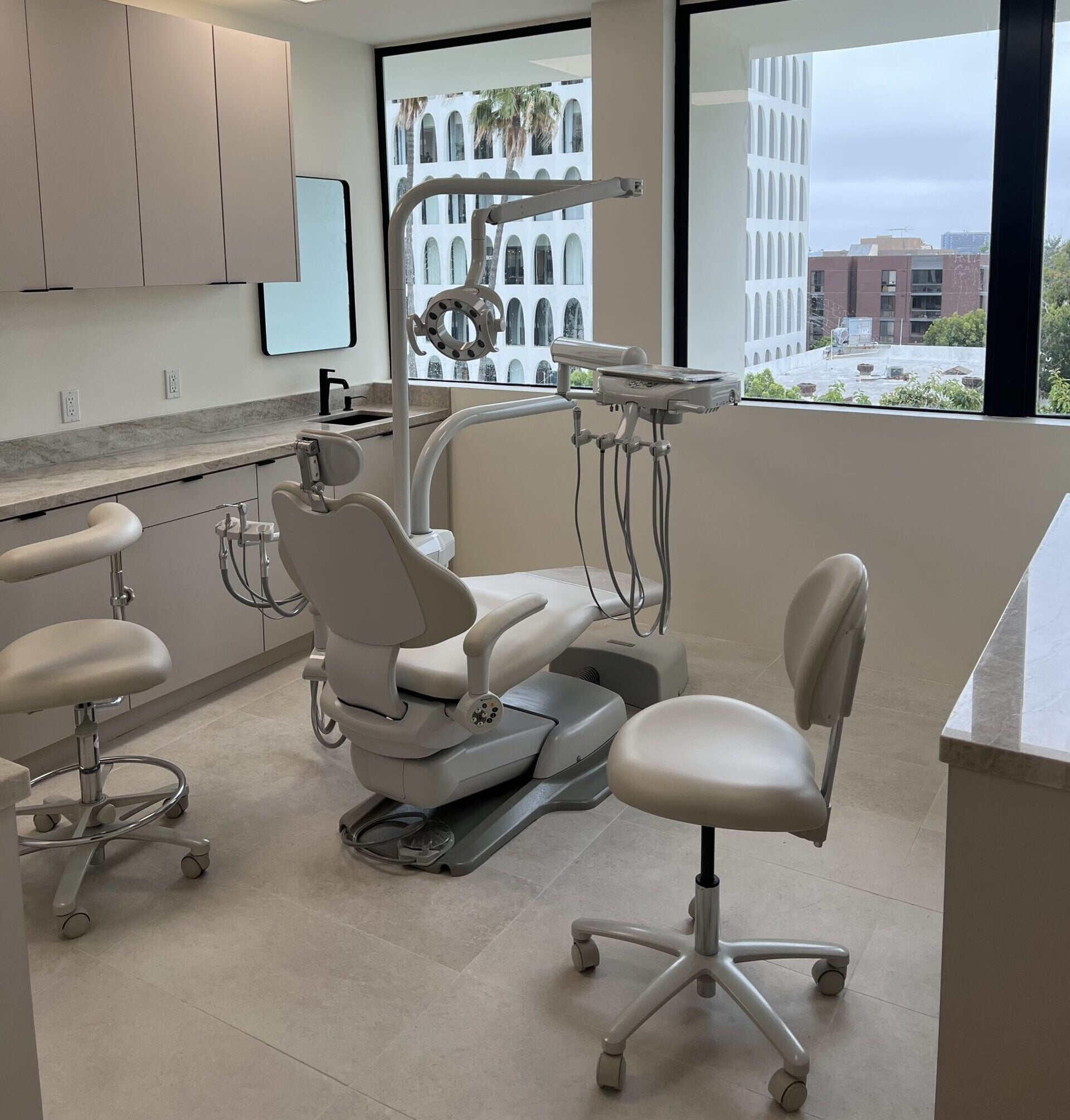 Empty dental treatment room with modern equipment - Emergency Dental Care A clean and professional dental operatory featuring advanced chairs and tools, ready for patient treatment - Emergency Dental Care