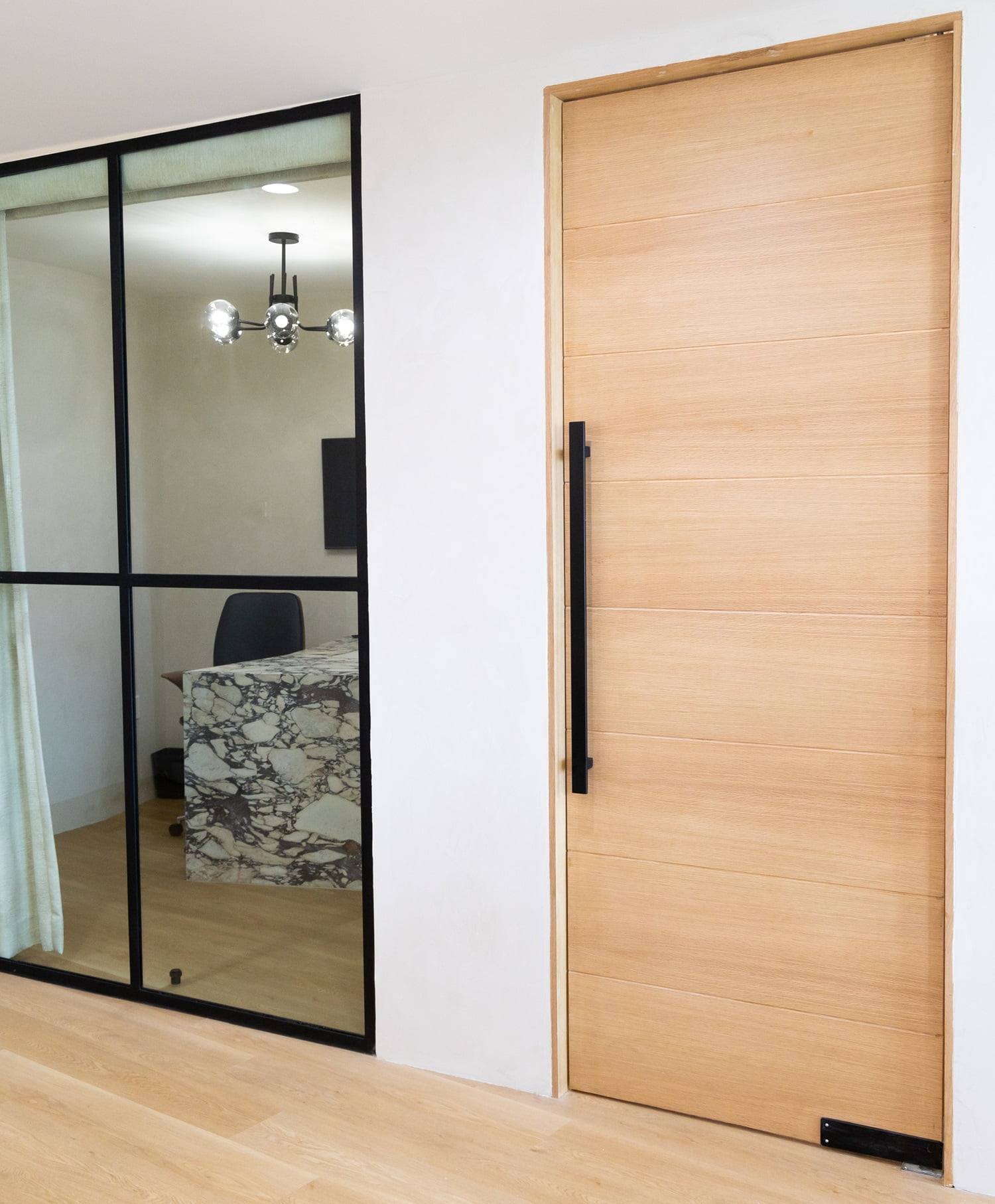 Modern dental office interior with private consultation room  Clean and modern dental office interior featuring wooden door, glass wall, and marble desk inside consultation room