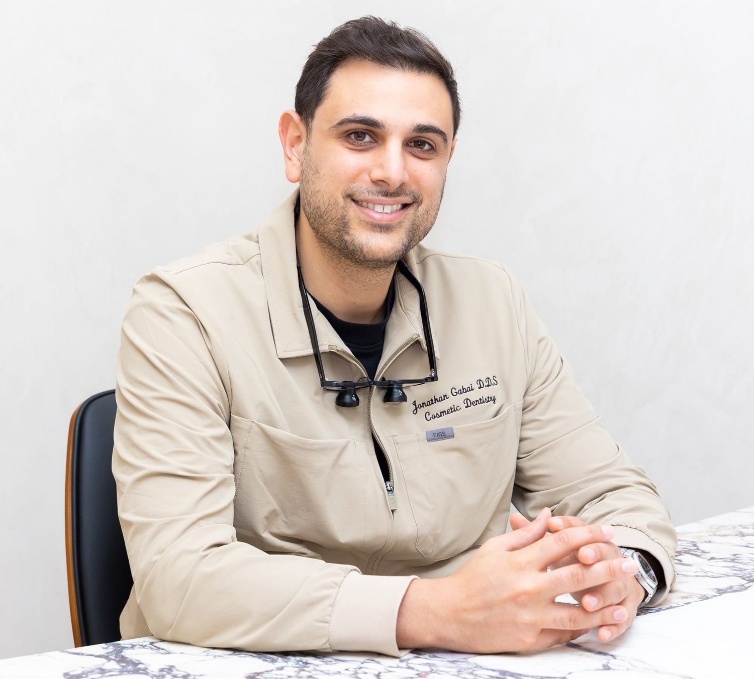 Dr. Jonathan Gabai, D.D.S. – Emergency & Cosmetic Dentist in Beverly Hills Portrait of Dr. Jonathan Gabai, D.D.S., emergency and cosmetic dentist in Beverly Hills, smiling in beige dental scrubs at his practice.